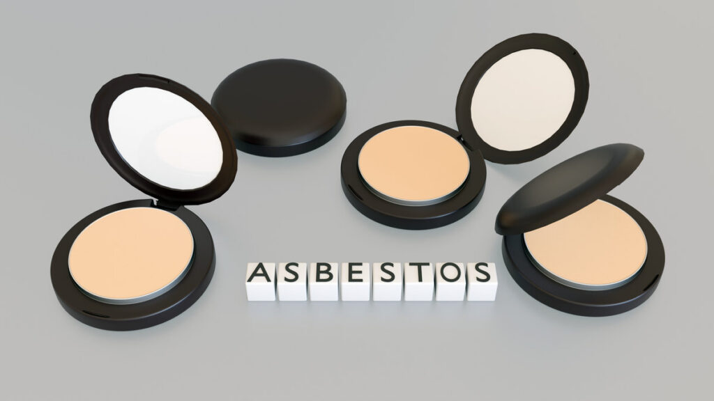 3D render of "ASBESTOS" on white blocks over an open makeup compact. It highlights the dangerous presence of asbestos fibers in talc-based cosmetic powders.