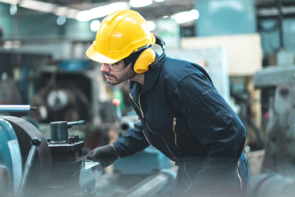 Industrial Engineers in Hard Hats.Work at the Heavy Industry Manufacturing Factory.industrial worker indoors in factory. man working in an industrial factory.Safety first concept.