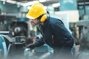 Industrial Engineers in Hard Hats.Work at the Heavy Industry Manufacturing Factory.industrial worker indoors in factory. man working in an industrial factory.Safety first concept.