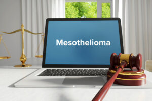 Mesothelioma ā Law, Judgment, Web. Laptop in the office with term on the screen. Hammer, Libra, Lawyer.