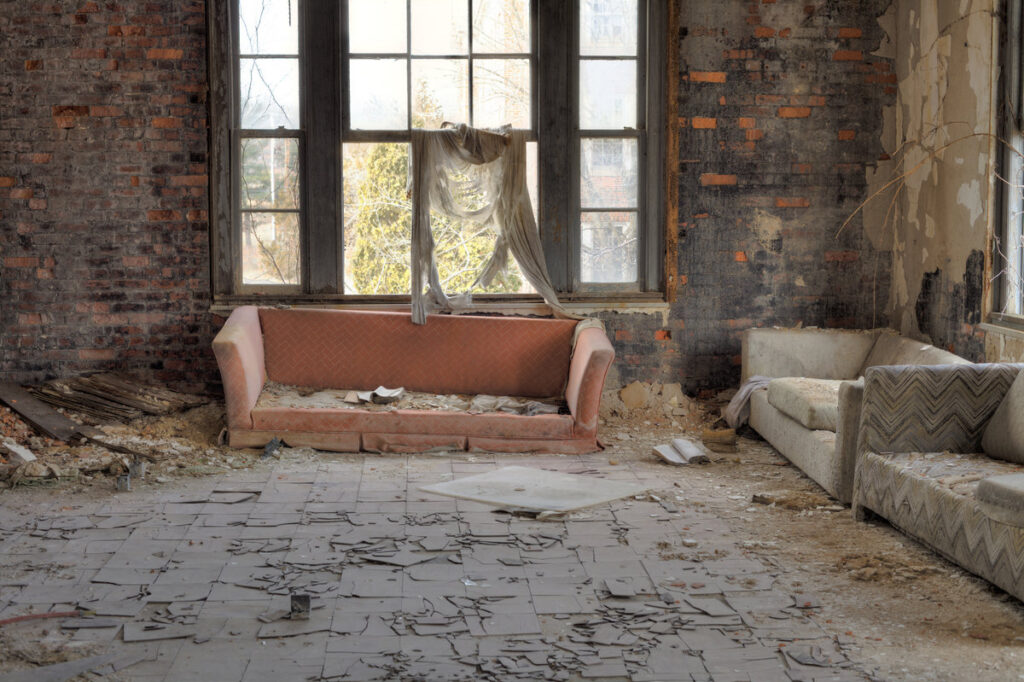 Urbex, abandoned house interior with cracked asbestos tiles, in light HDR processing