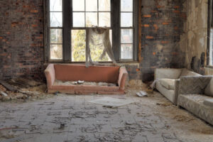 Urbex, abandoned house interior with cracked asbestos tiles, in light HDR processing