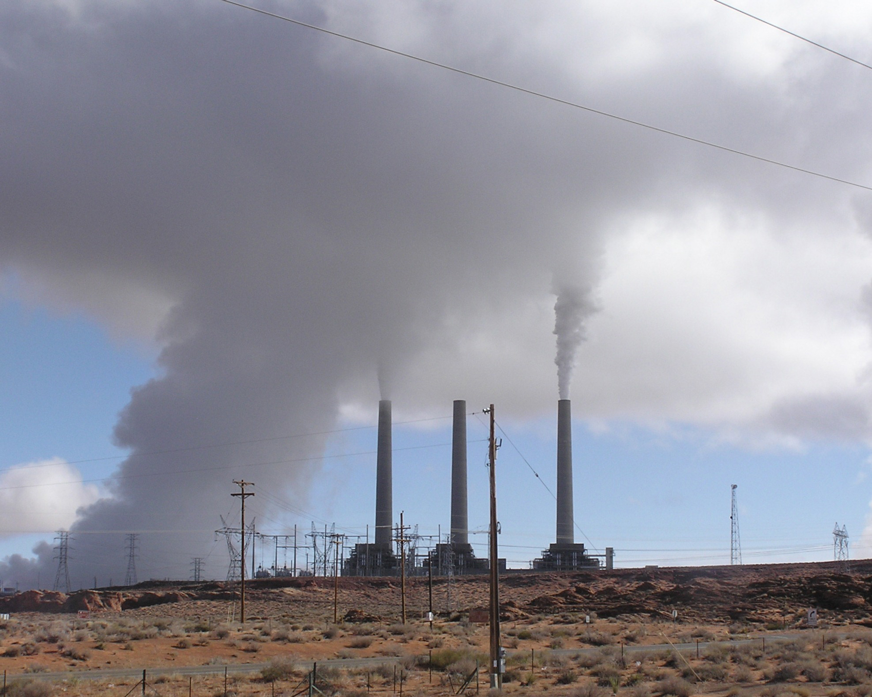 Navajo Generating Station near Page, Arizona, with three smokestacks releasing steam plumes